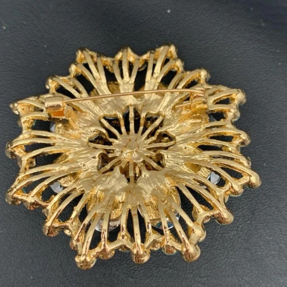 Gold tone and blue rhinestone brooch